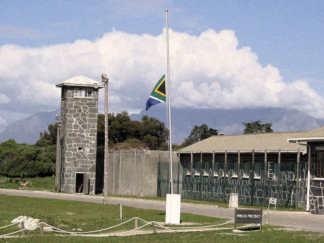Cell blocks and courtyard on Robben Island with Table Mountain in the distance