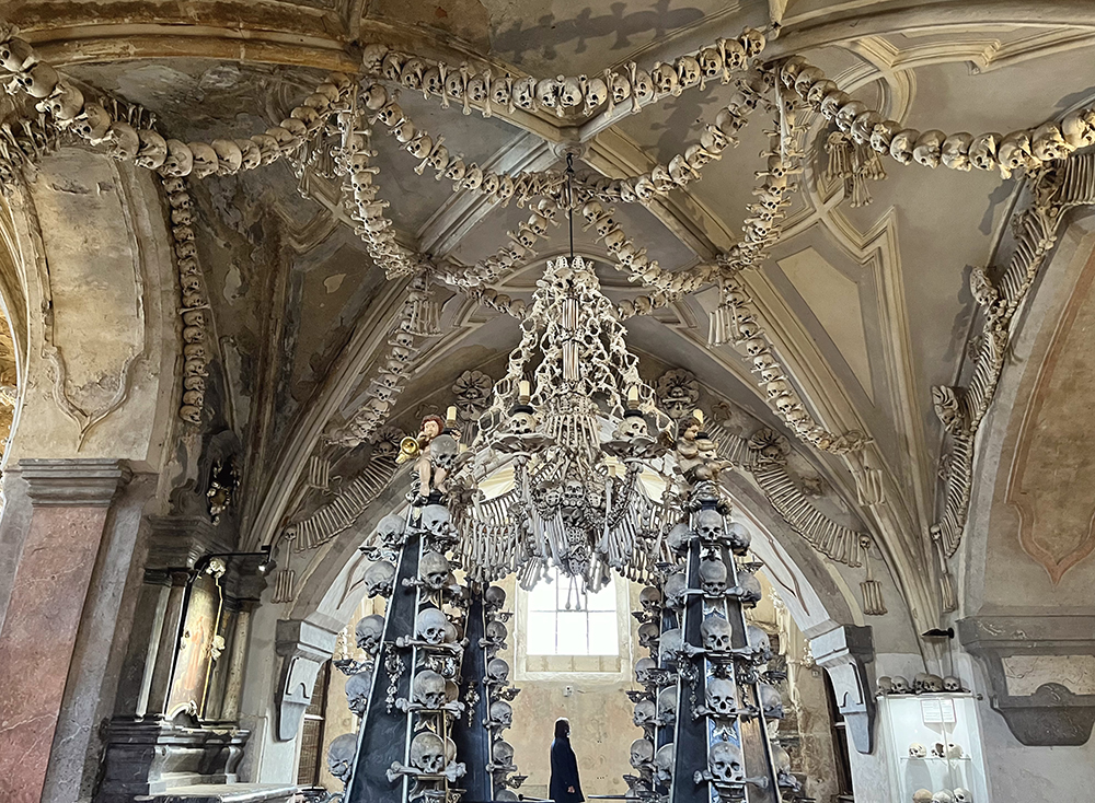 Sedlec Ossuary bone chandelier and skull-lined walls in Kutná Hora