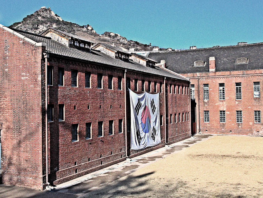 Red-brick cell blocks and guard towers at Seodaemun Prison in Seoul